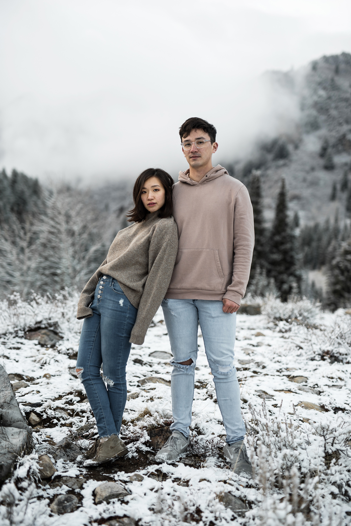 rad couple in front of a snowy mountain
