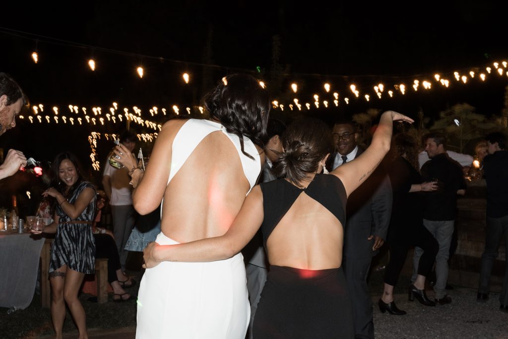 bride and bridesmaid dancing during their wedding