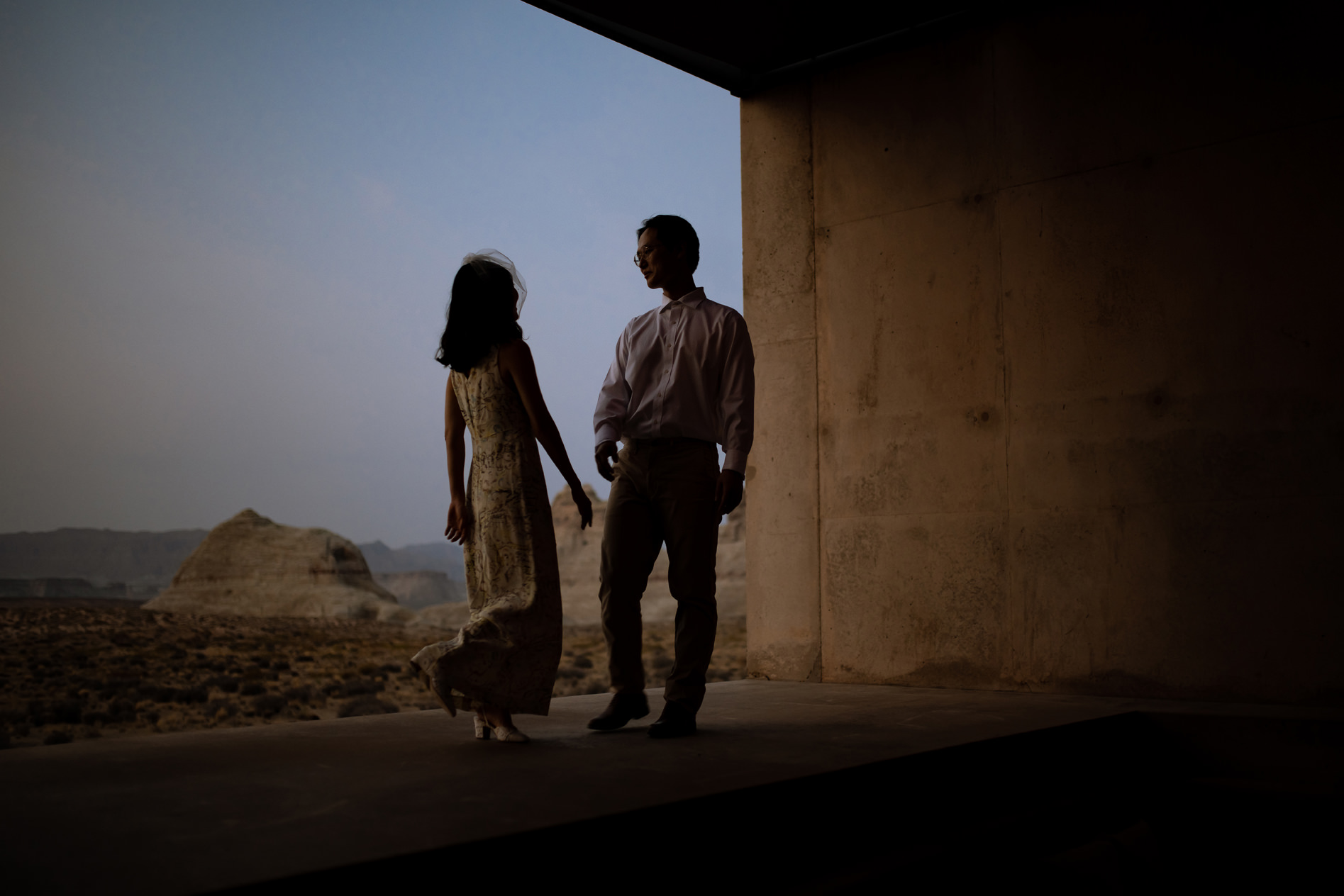 Couple barely lit by the dessert sunset at Amangiri.