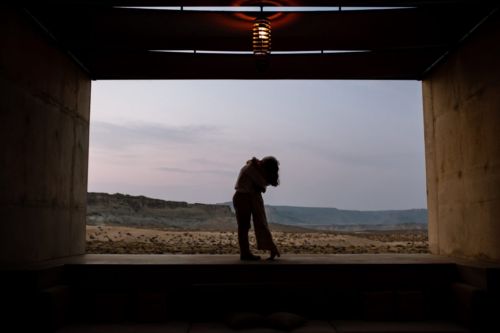 Lovers hugging silhouetted against the southern Utah dessert.