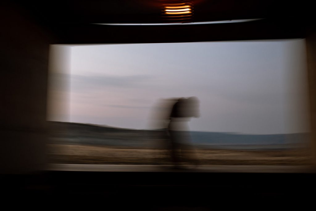 Blurred photo of couple dancing on the edge of Amangiri and the dessert.