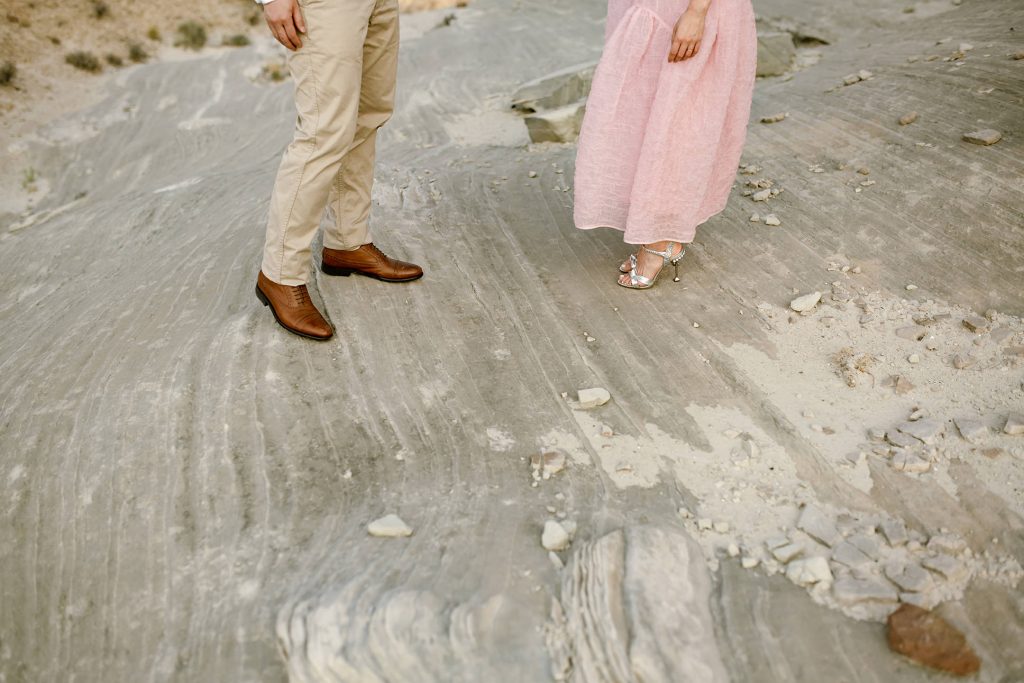 The couples feet highlighting how unstable the shale rock they're standing on.