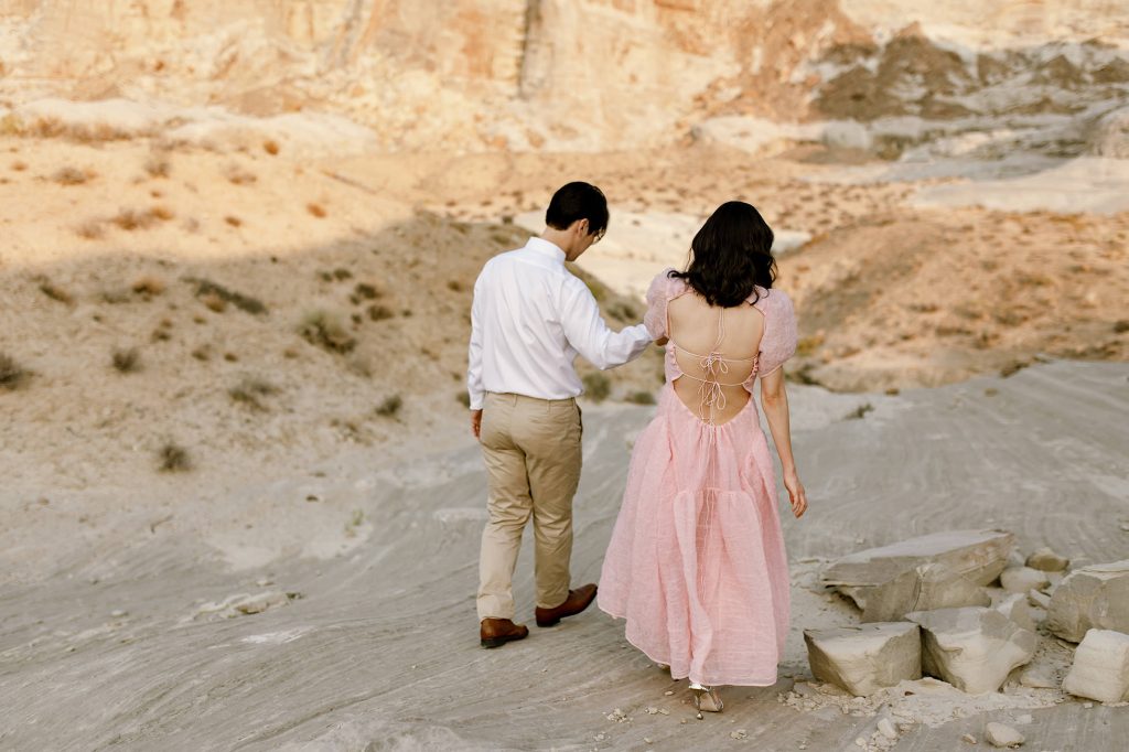 Jinoh leads his wife down the rocky hillside.