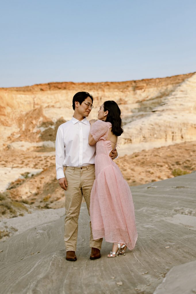 Jinoh holds his new wife while she faces him.