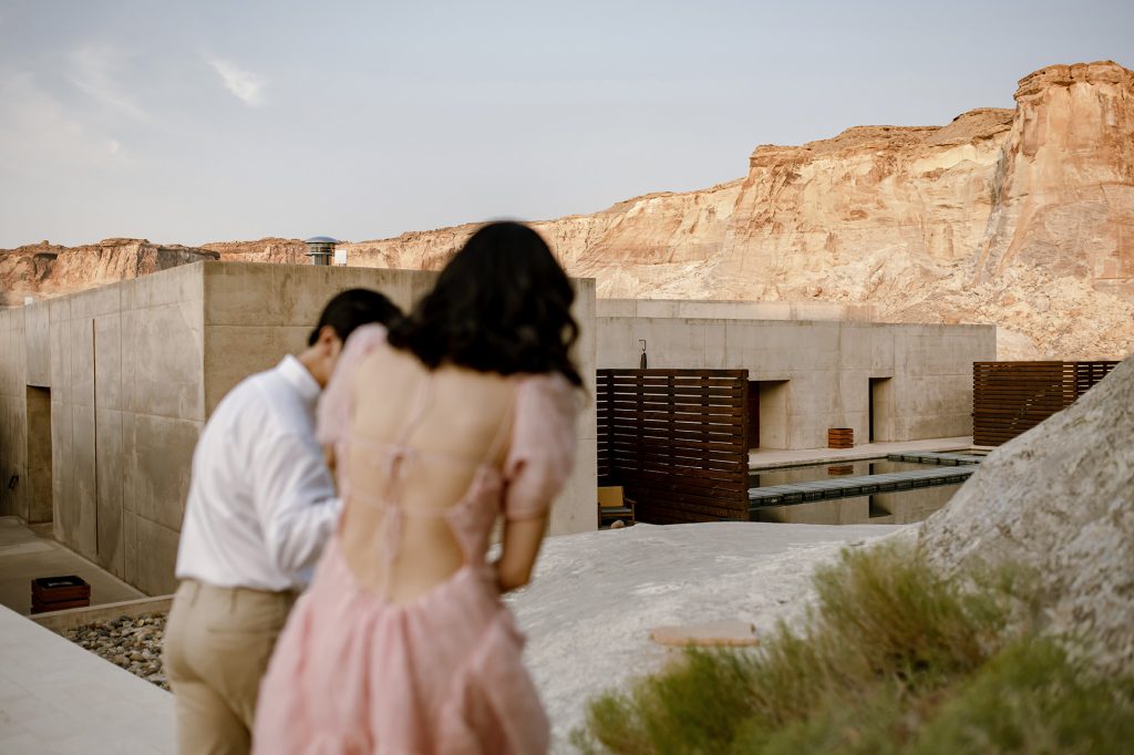 Husband and wife walk through the desert towards Amangiri.