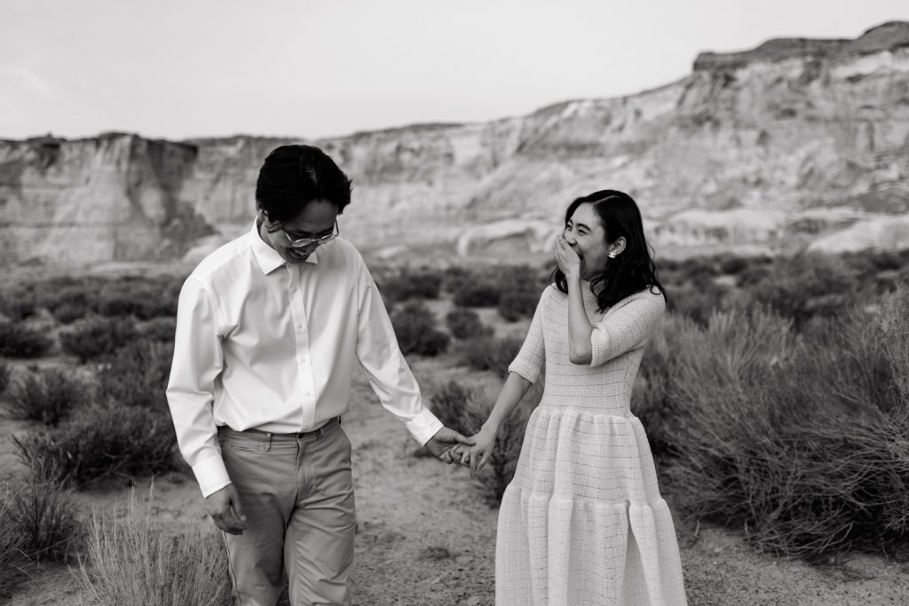 Husband and wife laugh together.