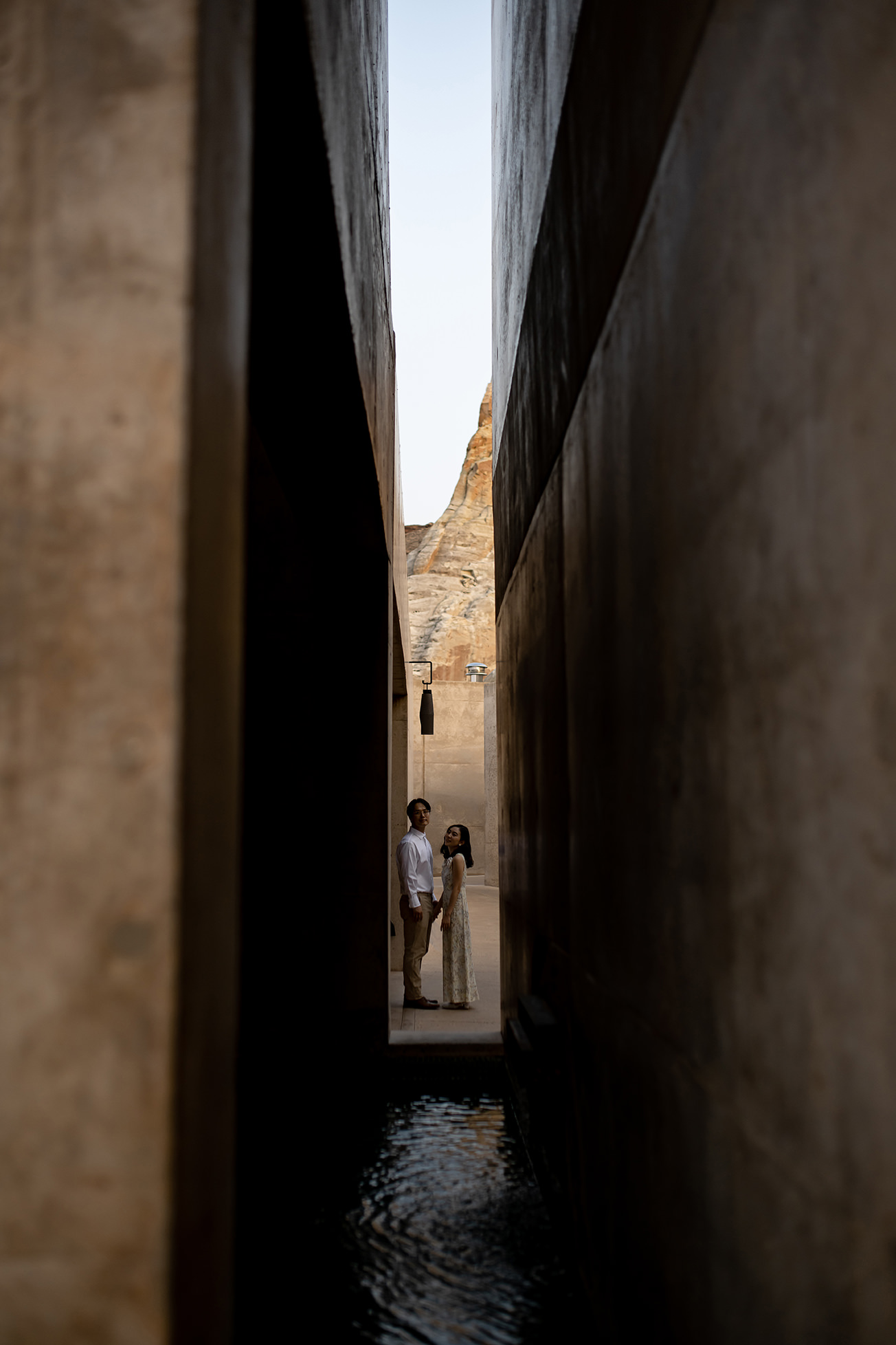 Bride and groom take a moment to themselves down an alley way.