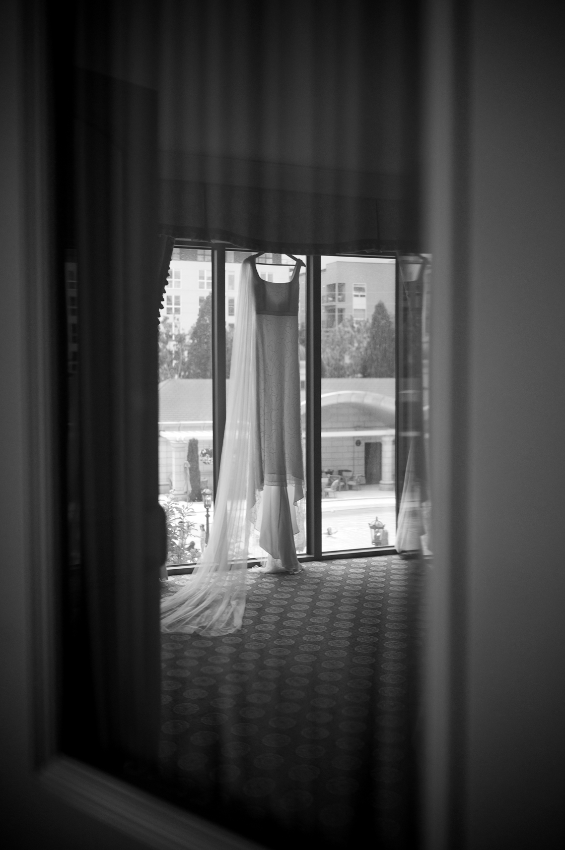 A sheer dress hanging in a window at the grand america hotel