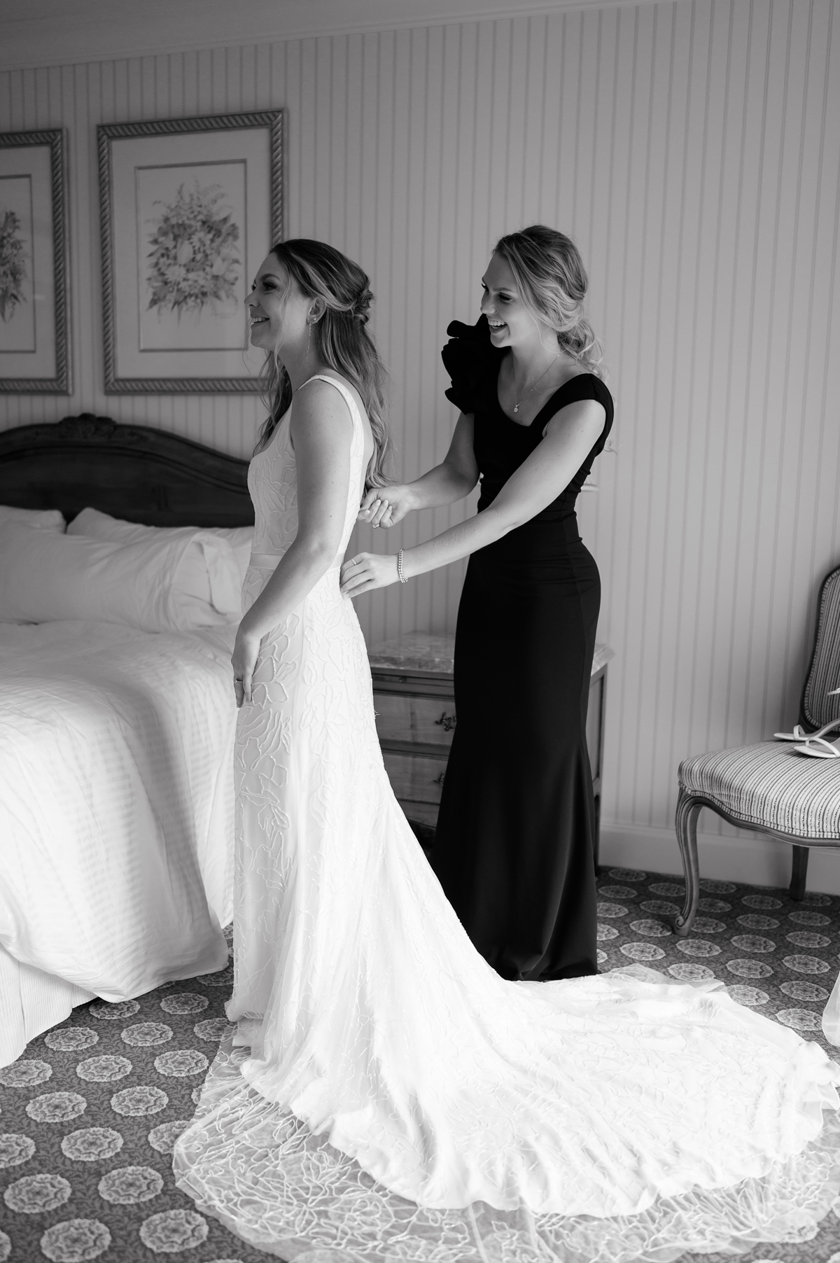a bride and maid of honor get dressed at grand america hotel