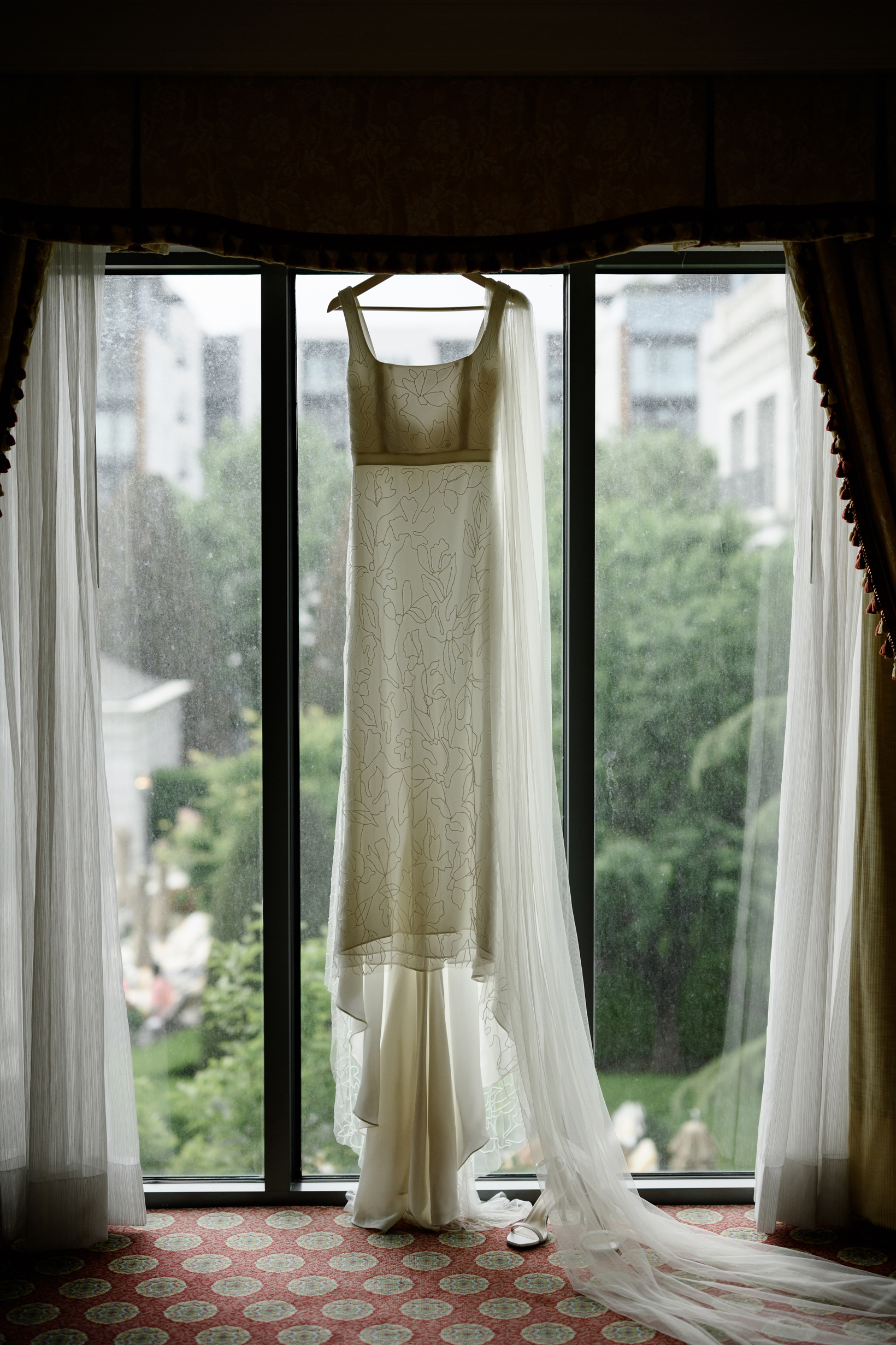 A sheer dress hanging in a window at the grand america hotel