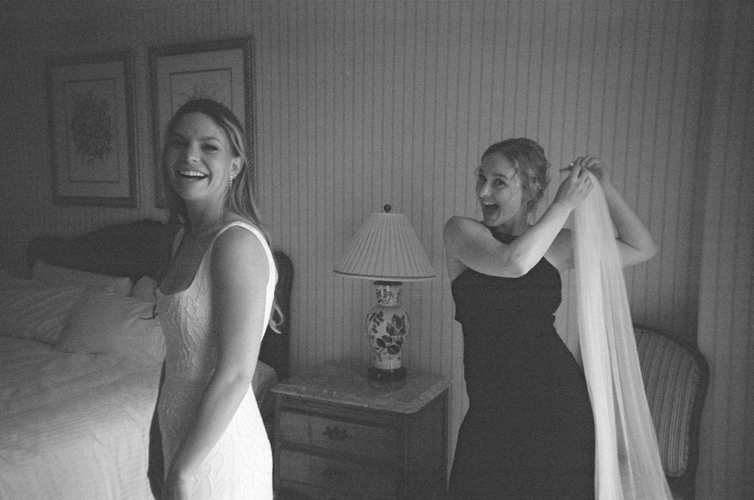 disposable camera photo of a bride getting ready with her maid of honor