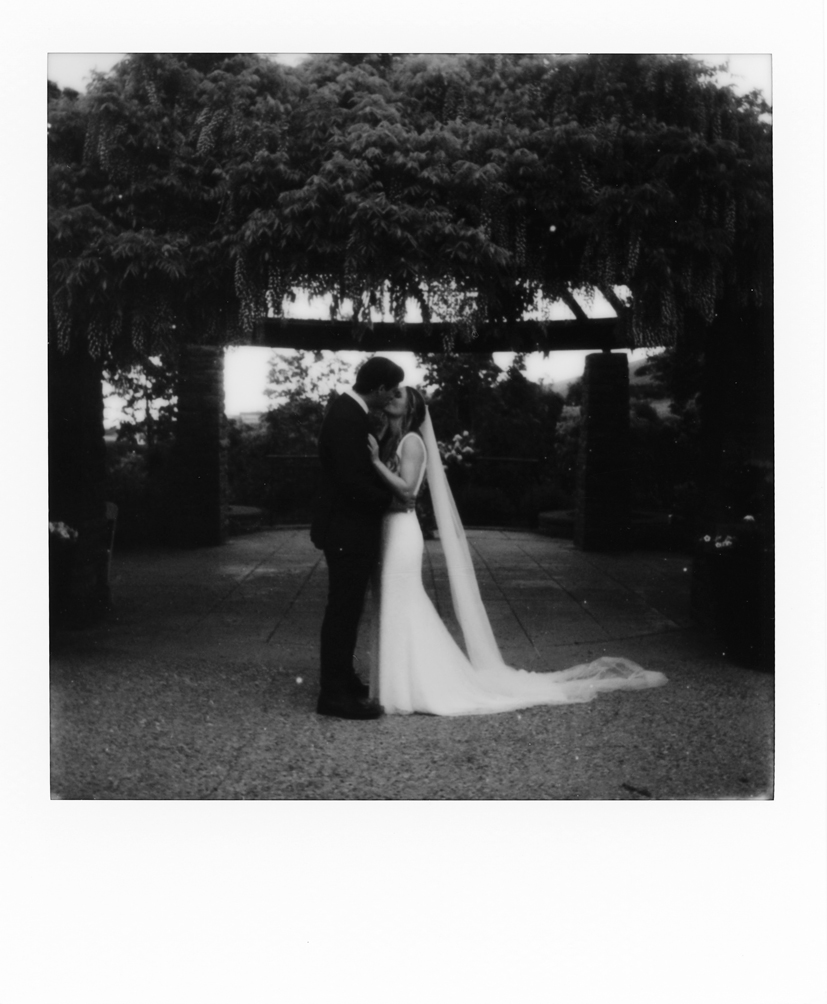 polaroid of a bride and groom kissing at red butte gardens